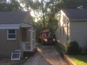 The crane had inches to spare getting between the houses.
